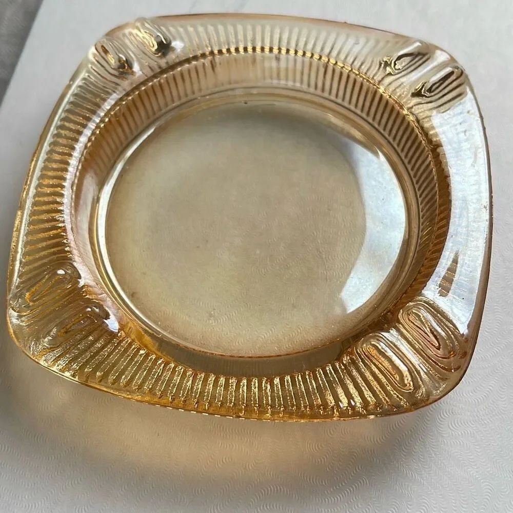 Vintage mid century Carnival glass ashtray. Peach in color.